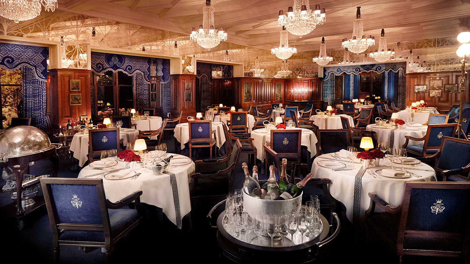 The dining room of George V Room, with 18th-century style chairs and crystal chandeliers